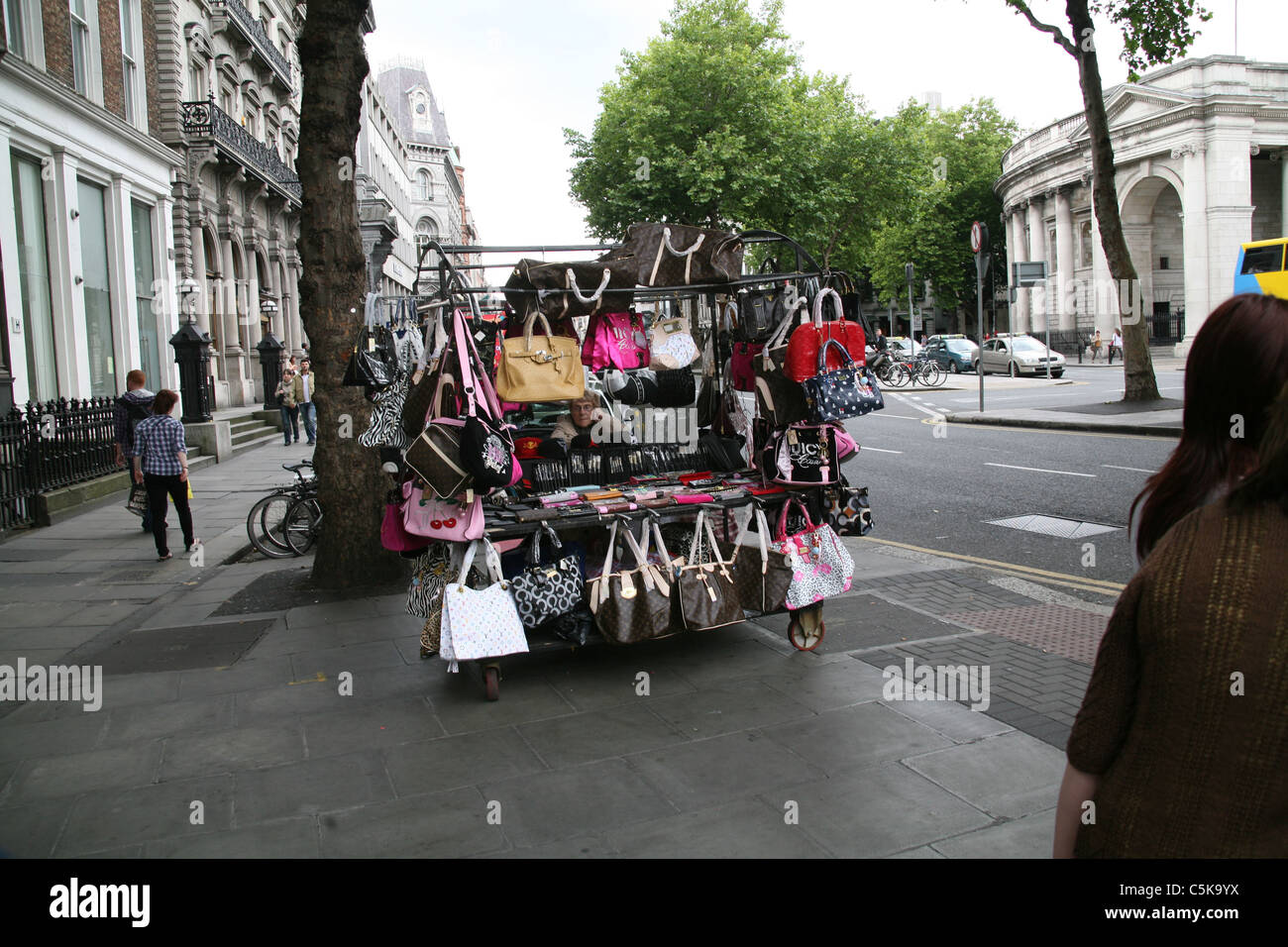 vendor illegally selling imitation name brand handbags on Canal Street  Manhattan New York Stock Photo - Alamy