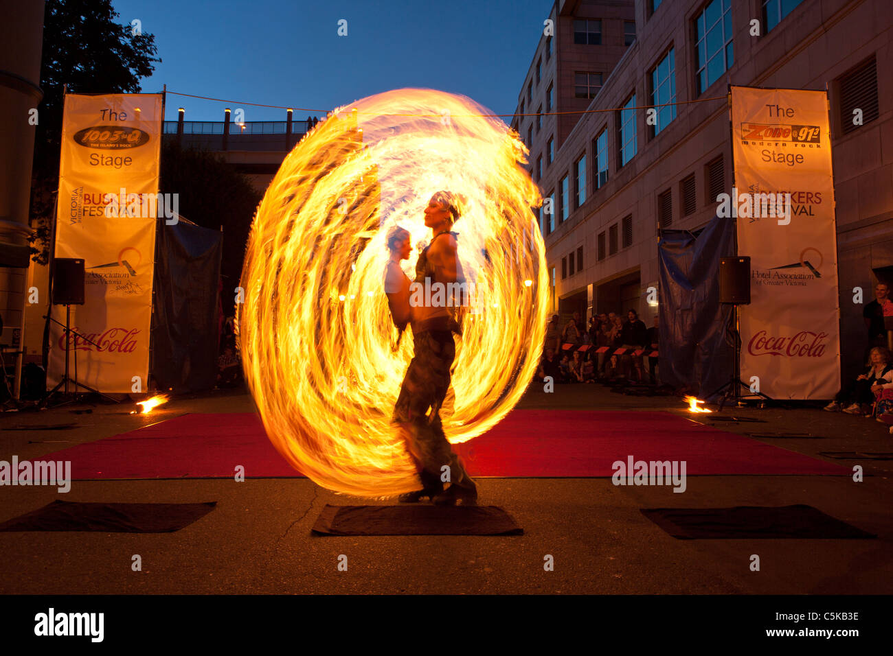 Flame Oz fire dancers entertaining at Victoria International Street Busker festival-Victoria, British Columbia, Canada. Stock Photo