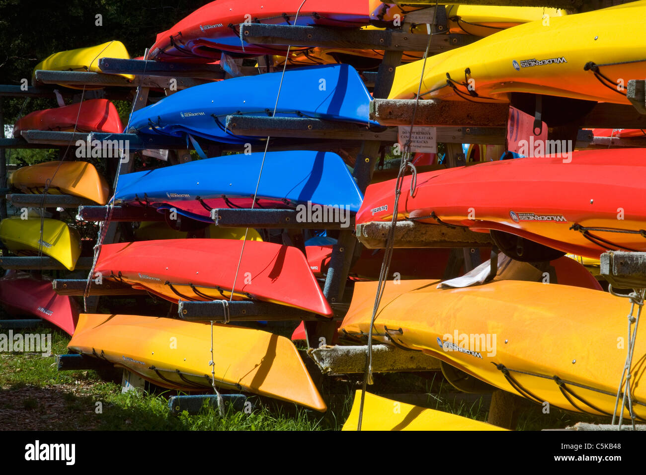 Colorful Kayaks stored for winter in Adirondack Mountains Stock Photo