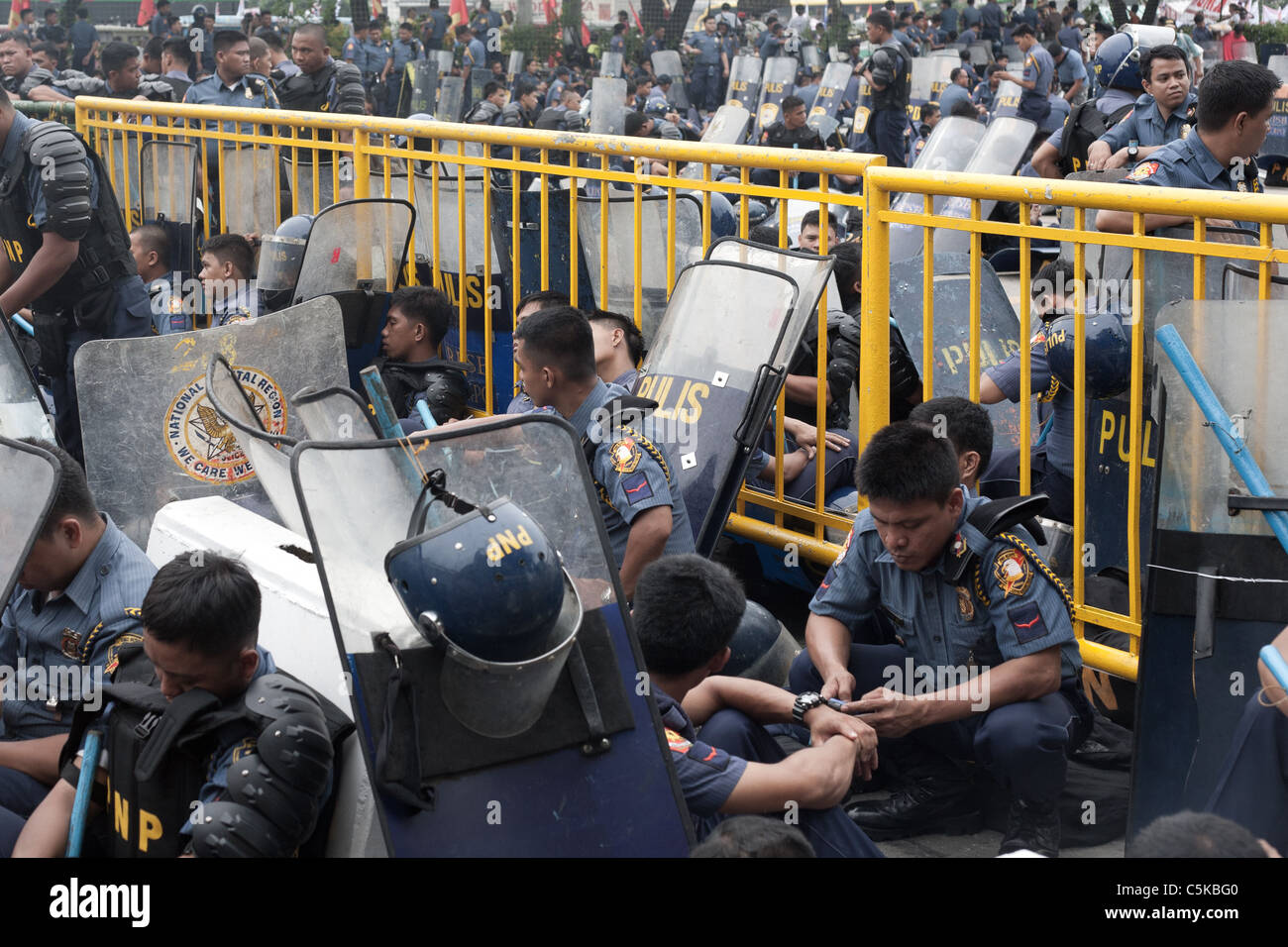 Riot police resting during protest rally during State of the Nation ...