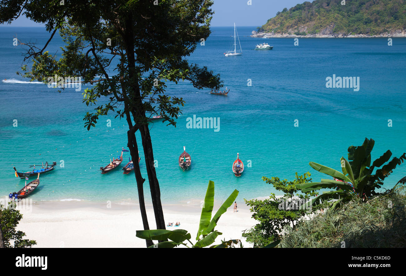 View over iconic tropical beach at 'Paradise Beach' from above with longtail boats and people on the beach Stock Photo