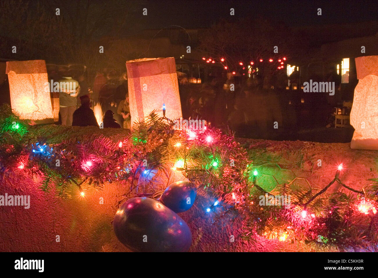Holiday lights and lanterns on adobe wall in New Mexico Stock Photo