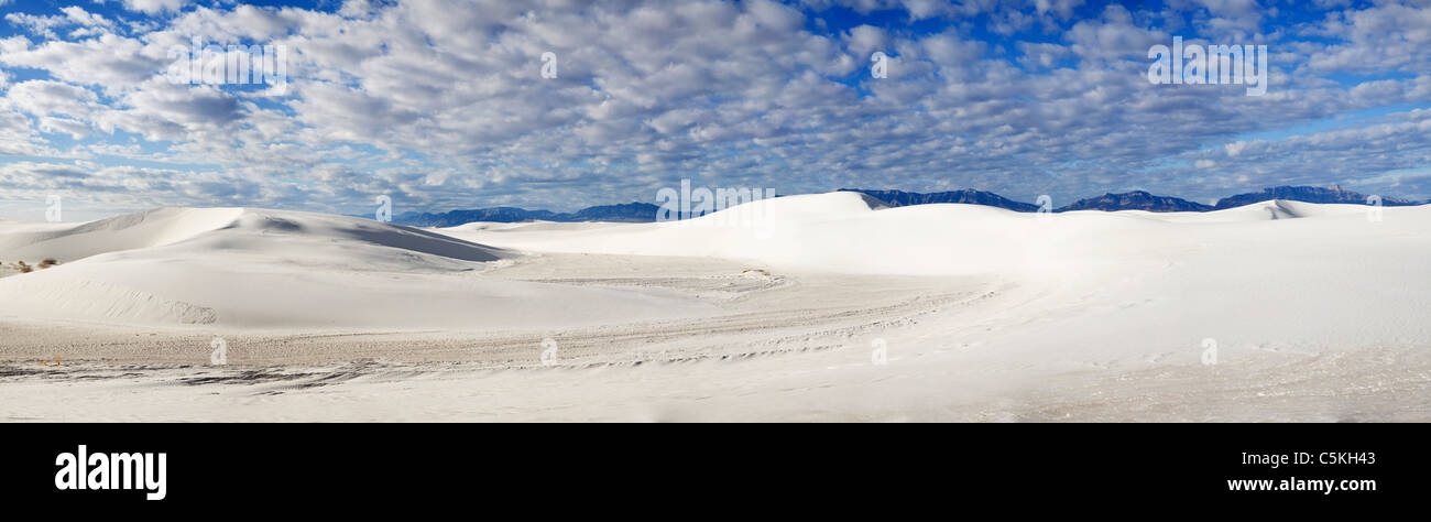 Panoramic of sand dunes at White Sands National Monument with blue skies and clouds. Stock Photo