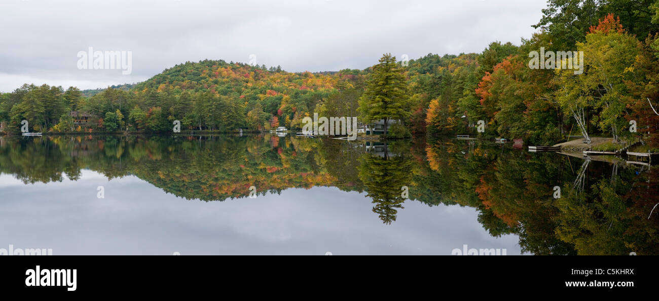 Fall color trees reflect in Partridge Lake, NH. Stock Photo