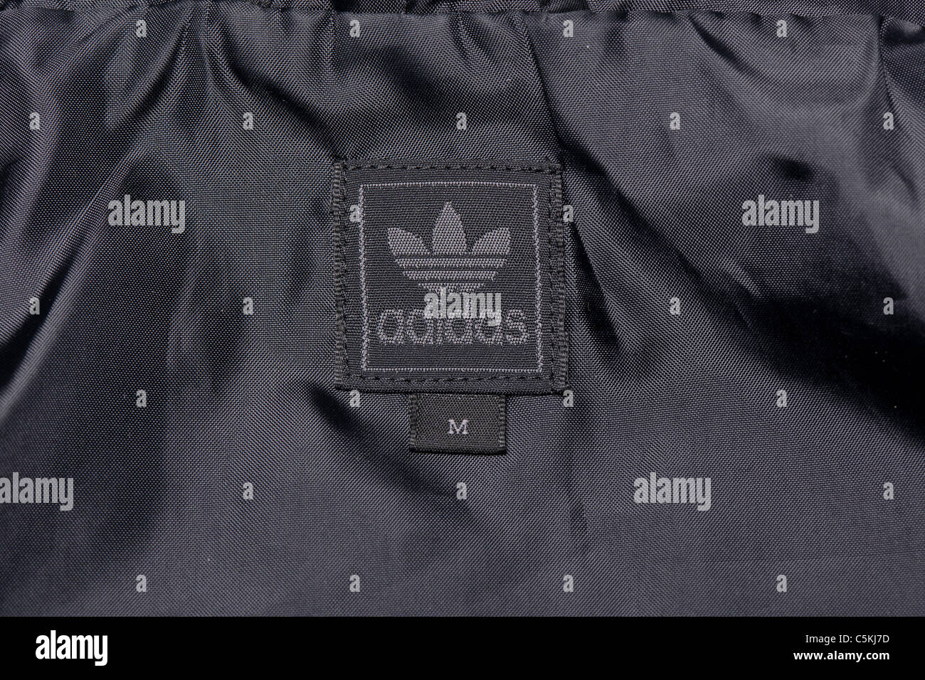 Adidas Paris range sportswear men's windbreaker jacket full zip hooded in nylon. With trefoil logo. Stock Photo
