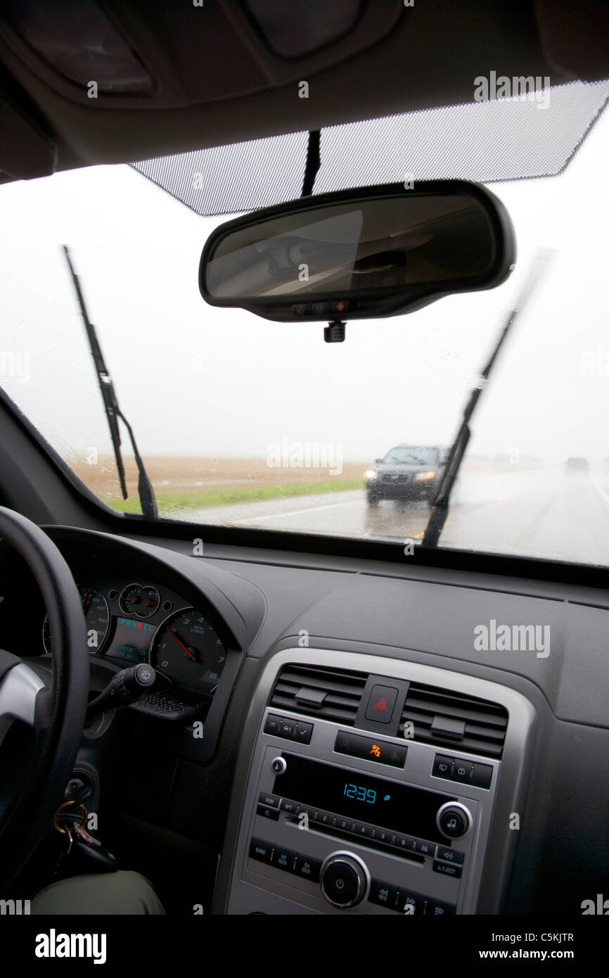 car driving through heavy rainstorm and flooding in southern saskatchewan canada Stock Photo