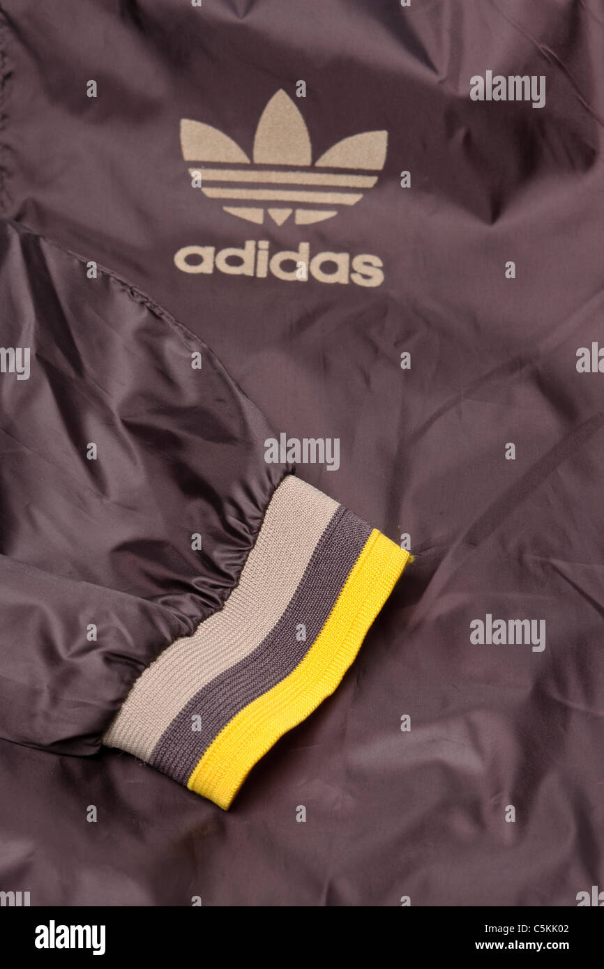 Adidas sportswear men's overhead windcheater rain jacket in brown nylon 1/4  zip to neck overhead jacket. Sleeve cuff detail Stock Photo - Alamy