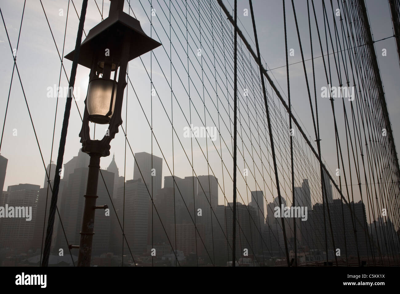 Lower Manhattan through Brooklyn Bridge archway, NYC Stock Photo