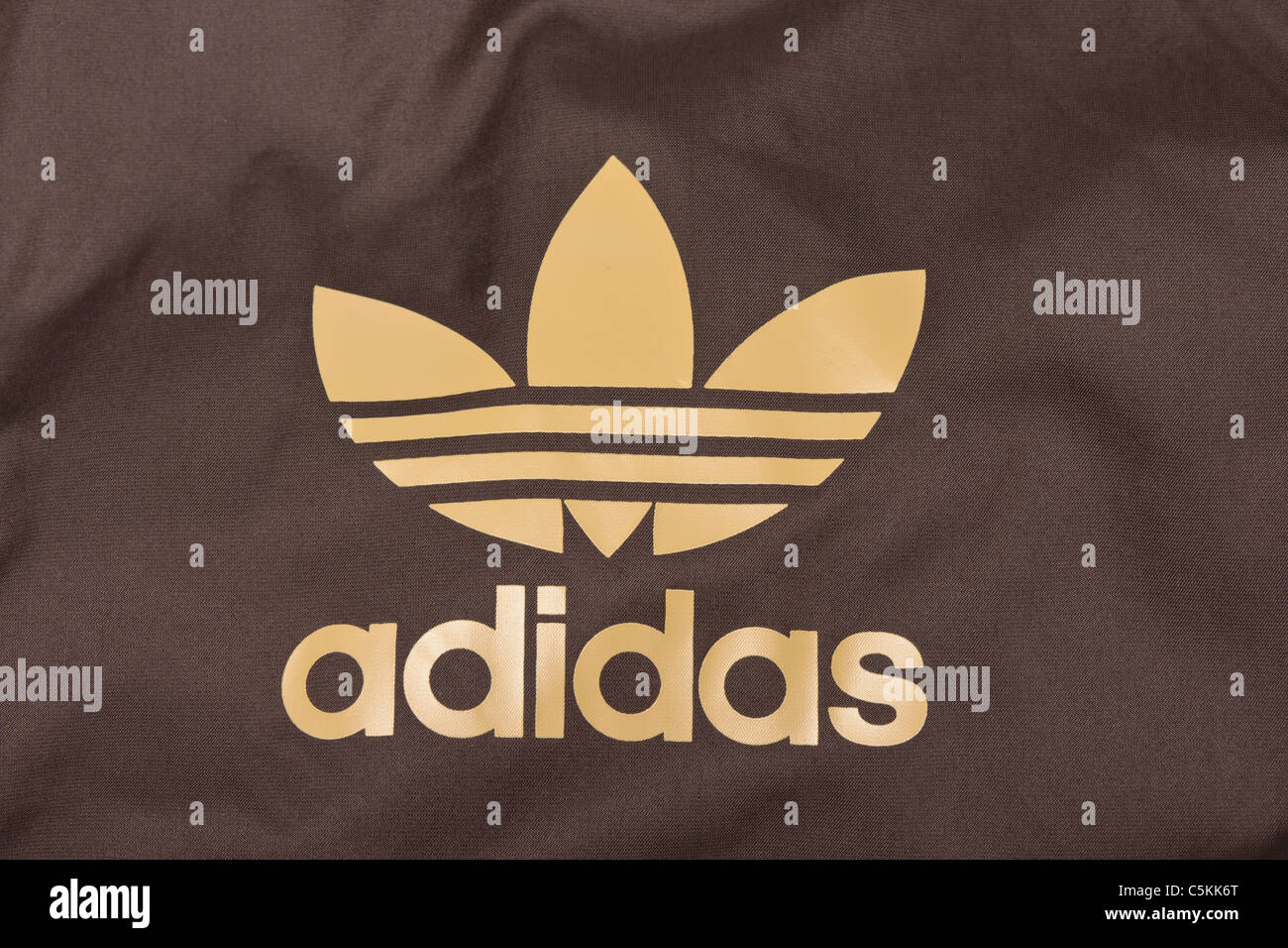 Adidas windbreaker windcheater men's sportswear jacket in brown nylon.  Hooded jacket. Trefoil logo detail Stock Photo - Alamy