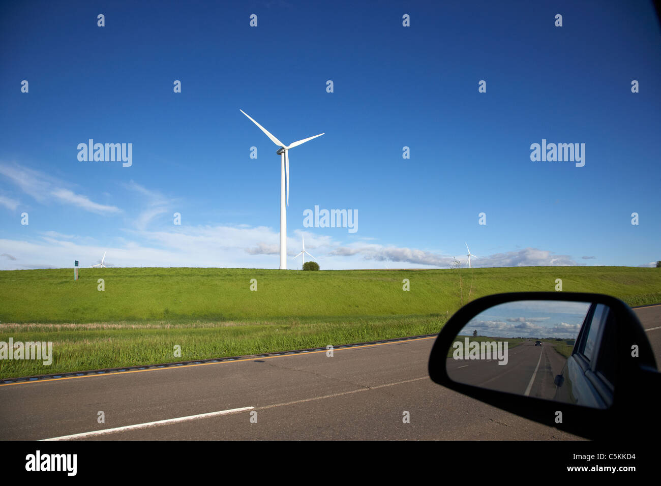 driving past wind turbine on windmill wind farm near minot north dakota