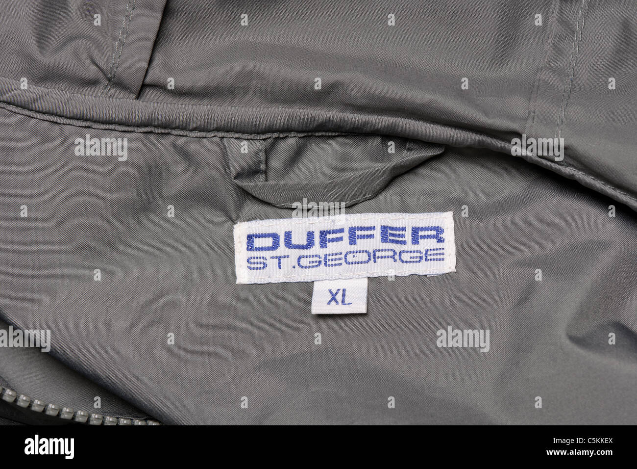 The Duffer of St George cagoule men's overhead rain jacket hooded in green. Label detail. Stock Photo