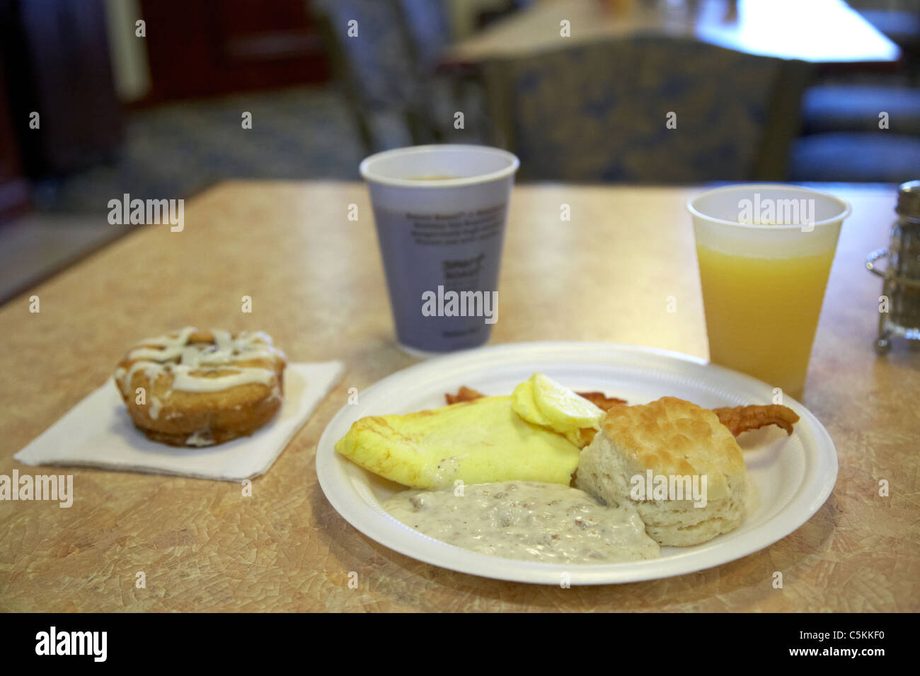 continental breakfast in a us hotel with biscuits gravy eggs coffee juice and pastry Stock Photo