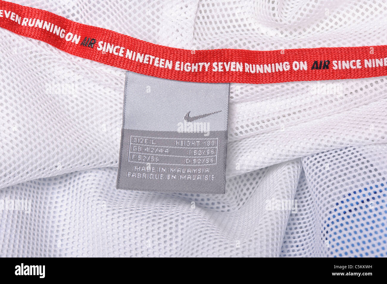 Nike Air windrunner sportswear men's nylon rain jacket full zip with hood. Wash care label detail Stock Photo