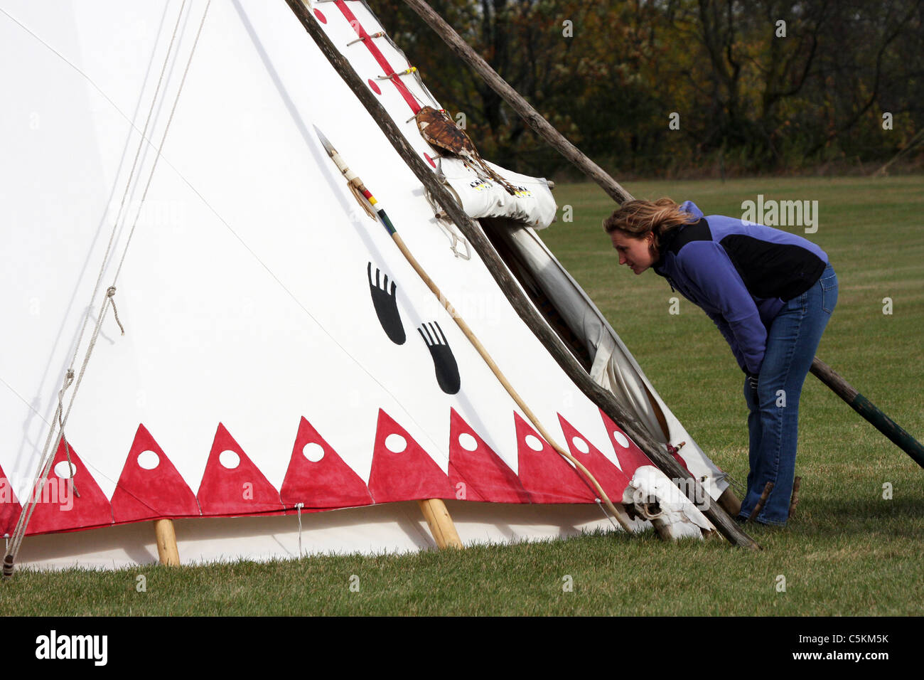 A curious person looking inside a Native American Indian tipi Stock Photo