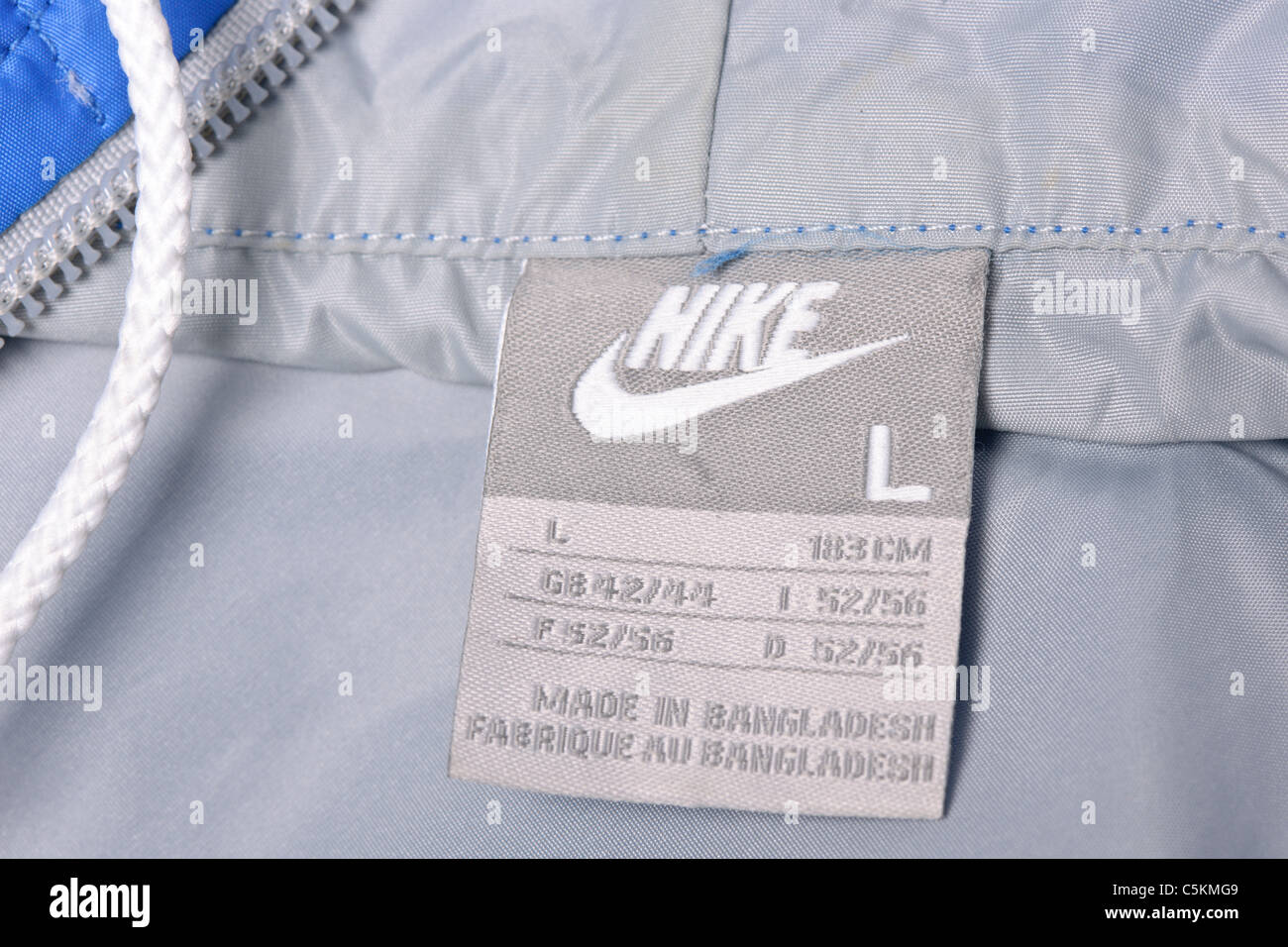 Men's Nike Windrunner jacket in blue/grey clothing wash care label detail Stock Photo
