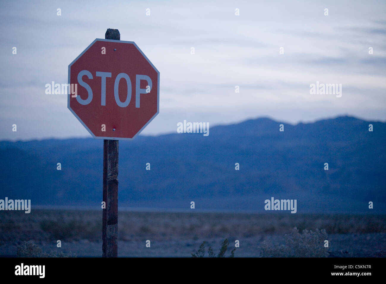 Stop sign and arid wilderness, Death Valley; CA Stock Photo