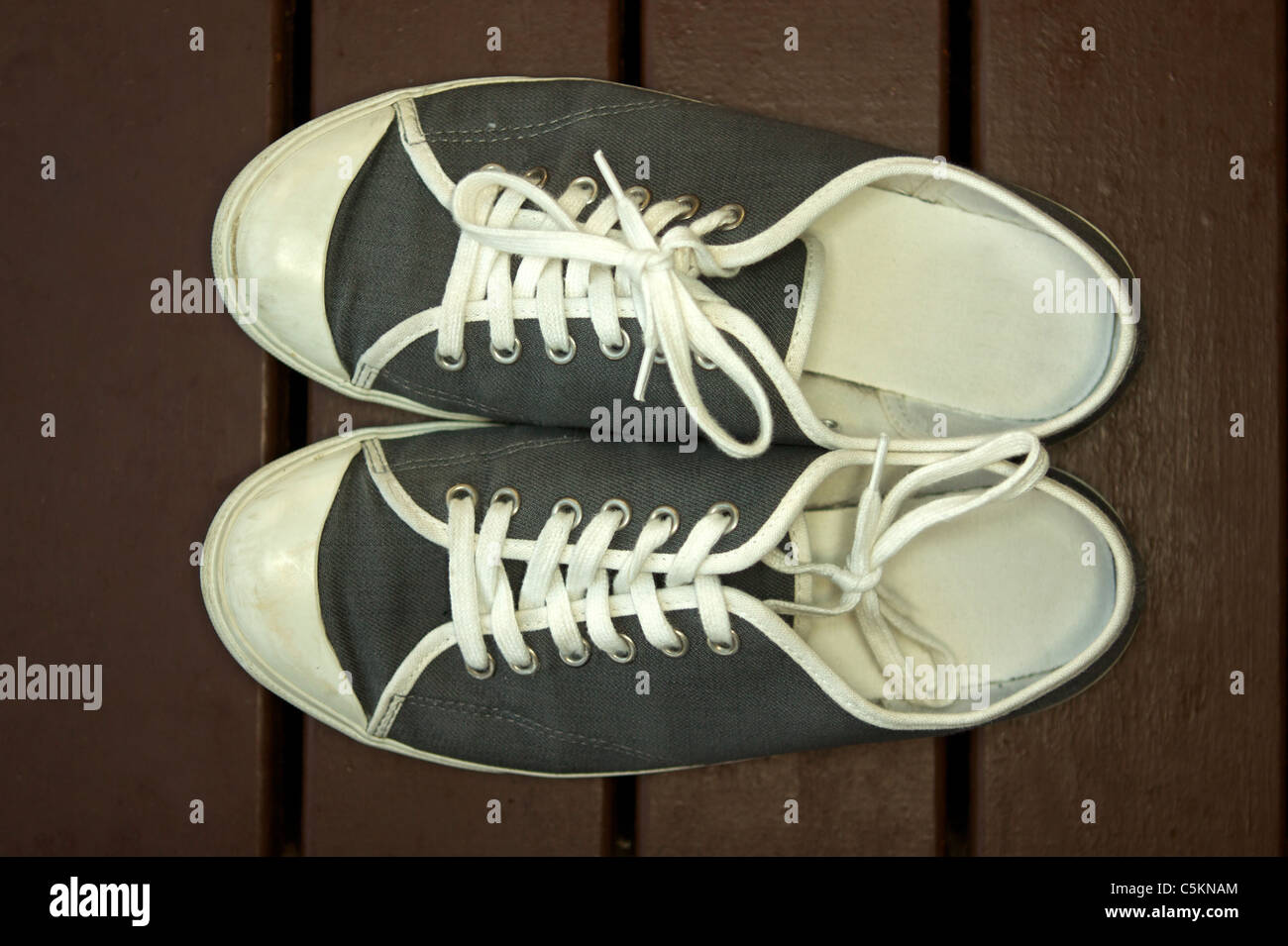 Sneakers on a wooden isolated on a deck Stock Photo - Alamy