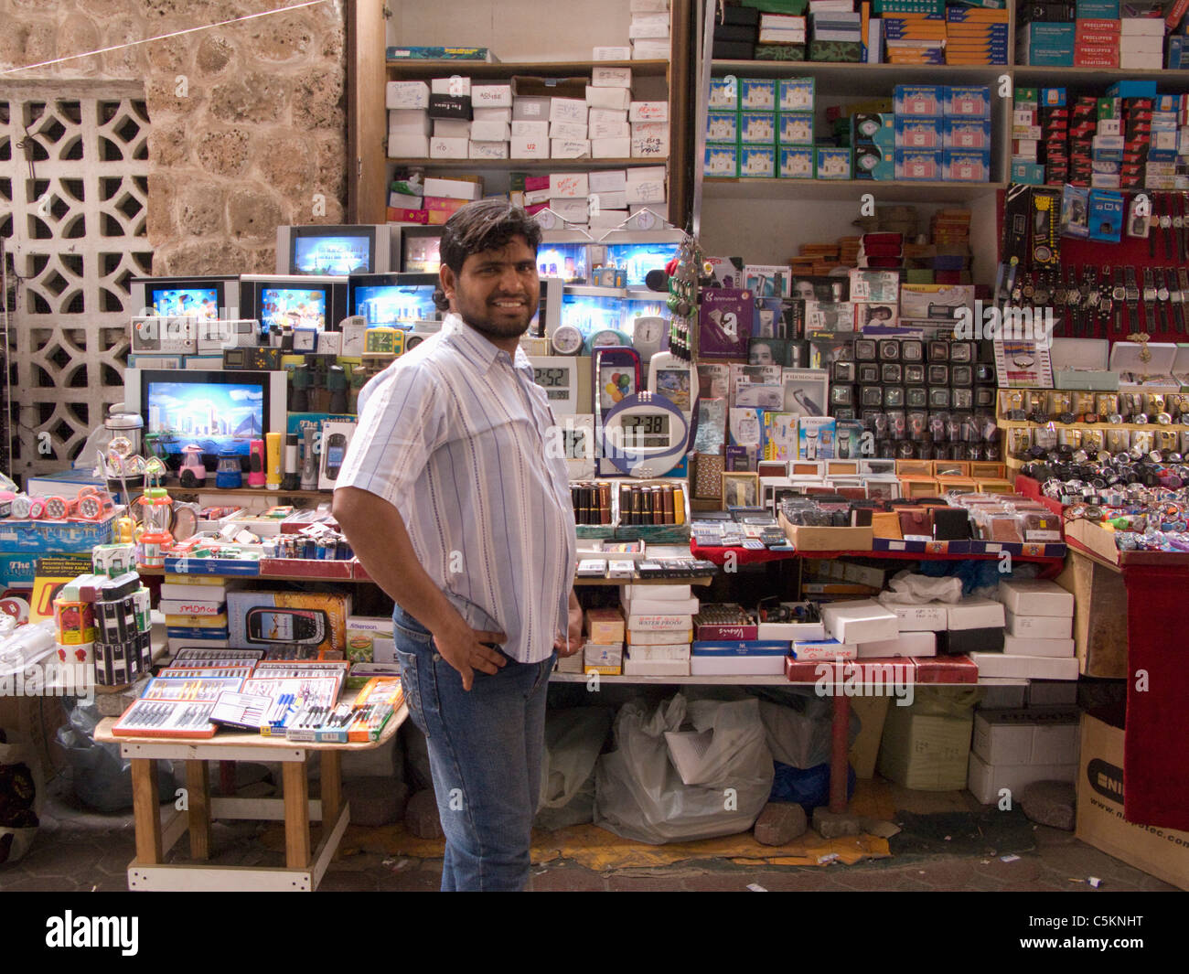 Man in front of his market stall in the Suq, Dubai, United Arab Emirates Stock Photo