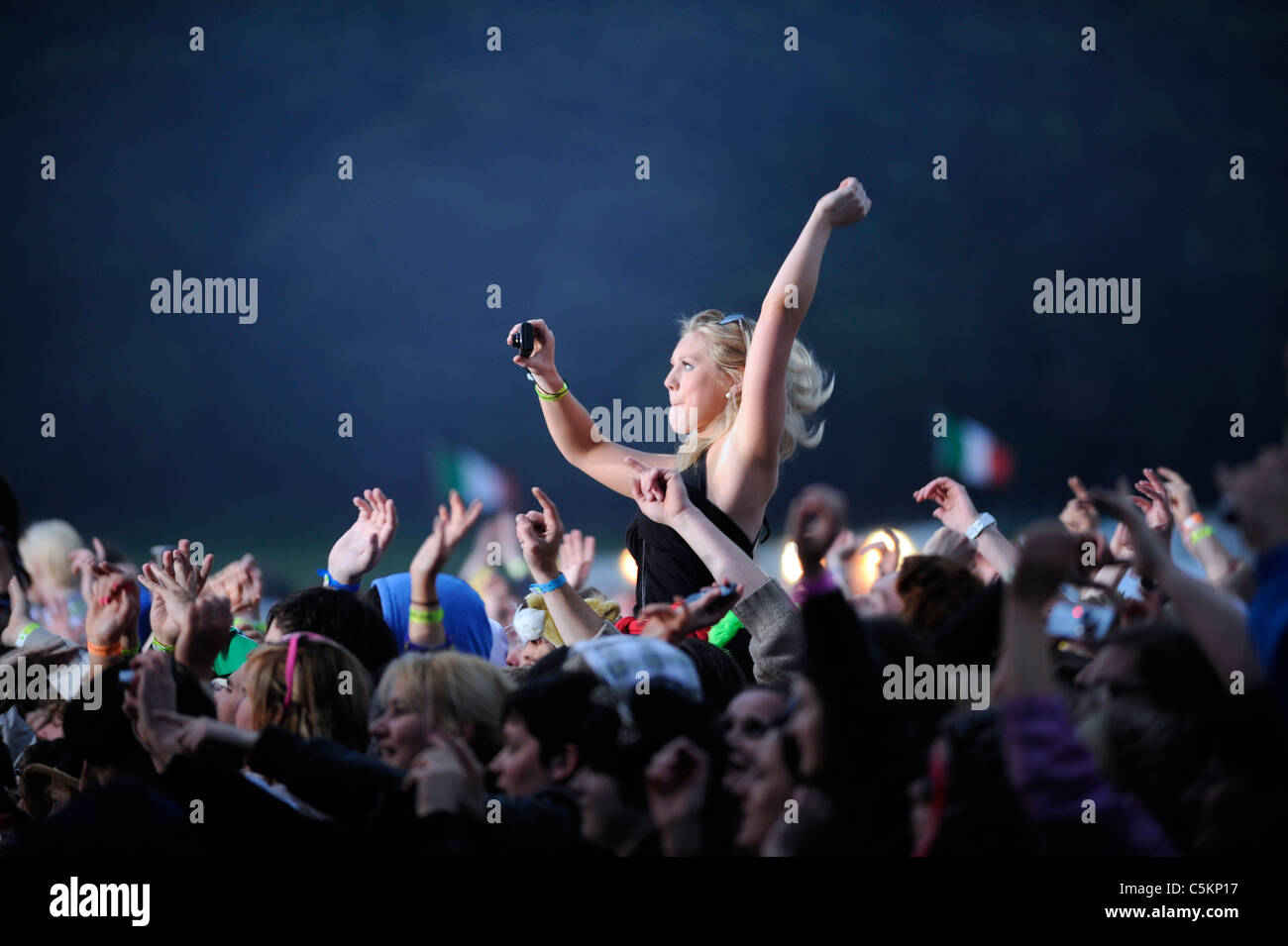 Female musi fan at festival takes pictures with her camera Stock Photo