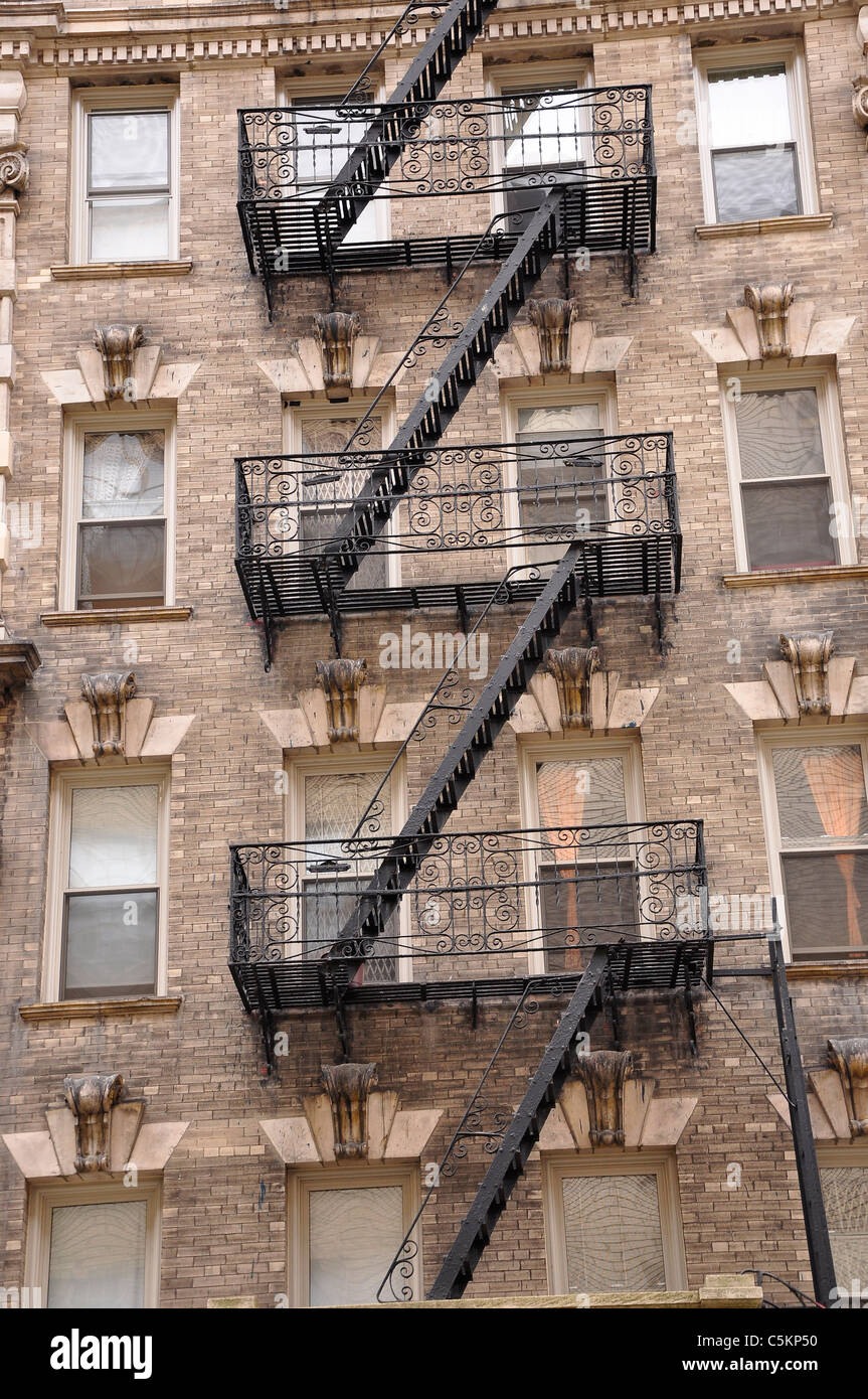 Zig zagging fire escape on the exterior of old apartment building in New York City. Stock Photo