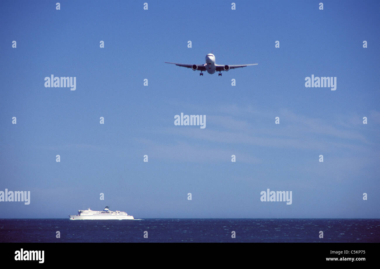 Boeing 767 airliner of Qantas Airways on final approach to Wellington Airport, New Zealand, flies over interisland ferry Stock Photo