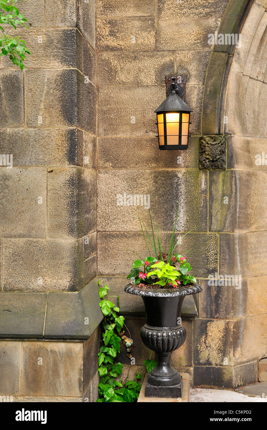 Exterior light and large flower pot outside a church in Manhattan, New