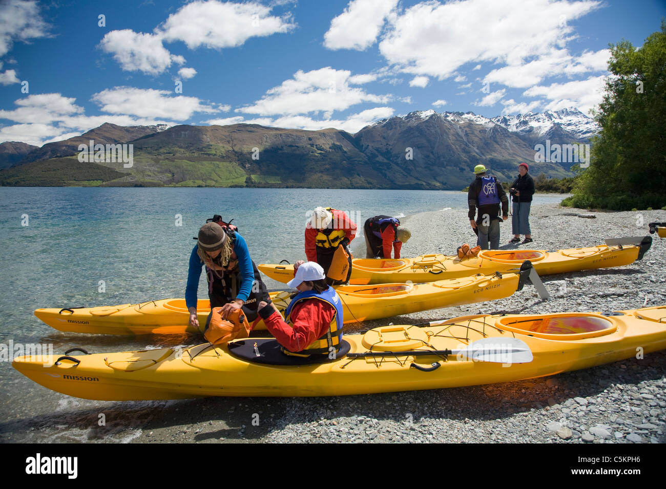 Group of people preparing to go kayaking on Lake Wakatipu near Queenstown, New Zealand Stock