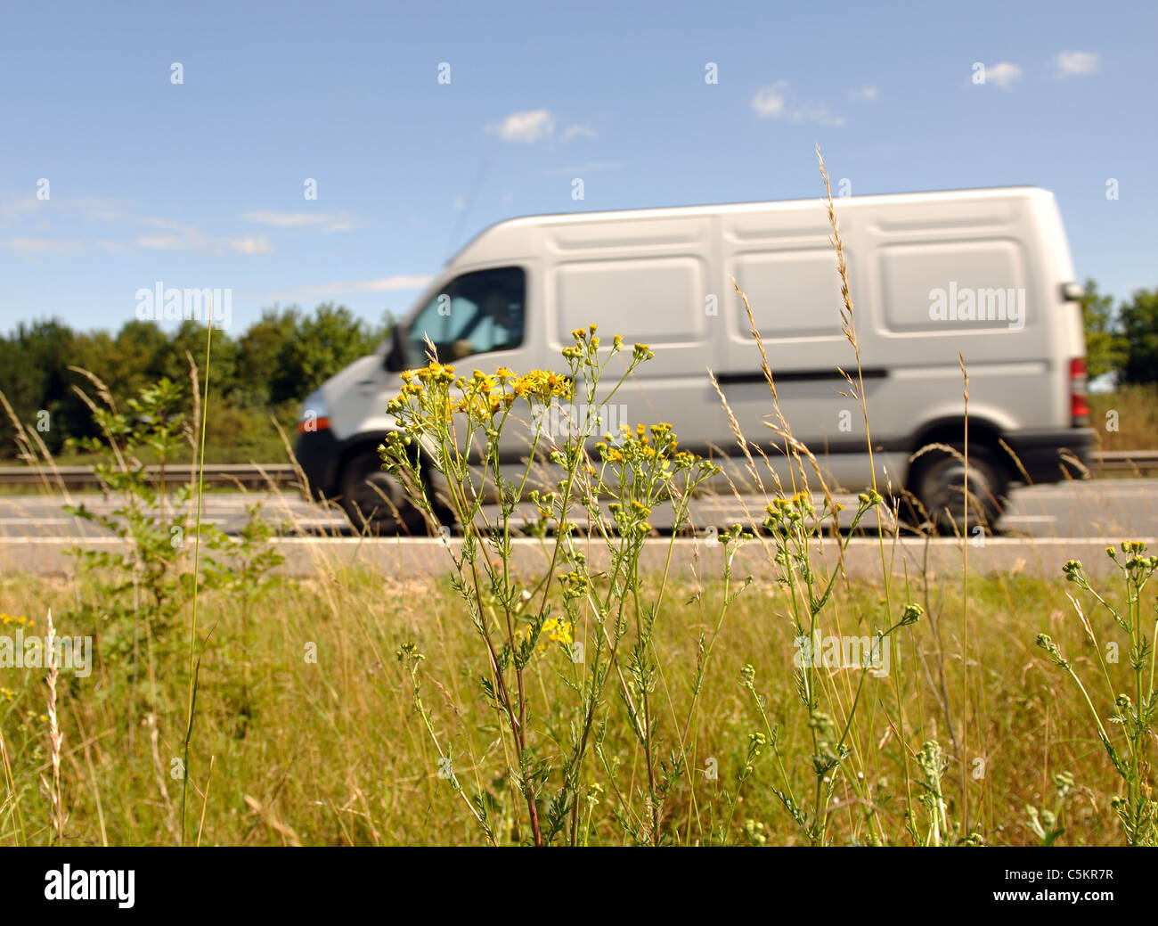 M40 motorway verge with white van passing, Warwickshire, UK Stock Photo