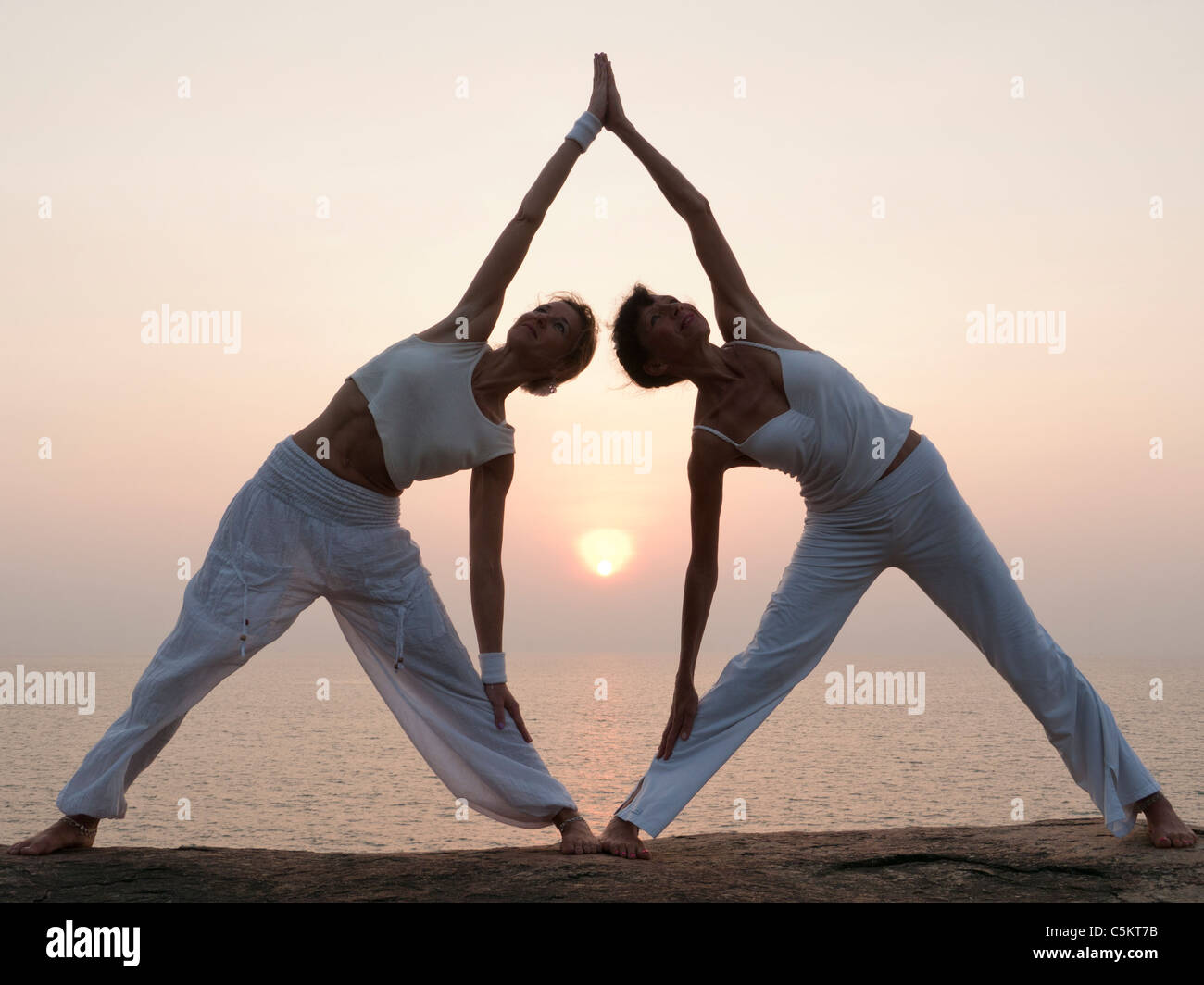 Two women making yoga together Stock Photo