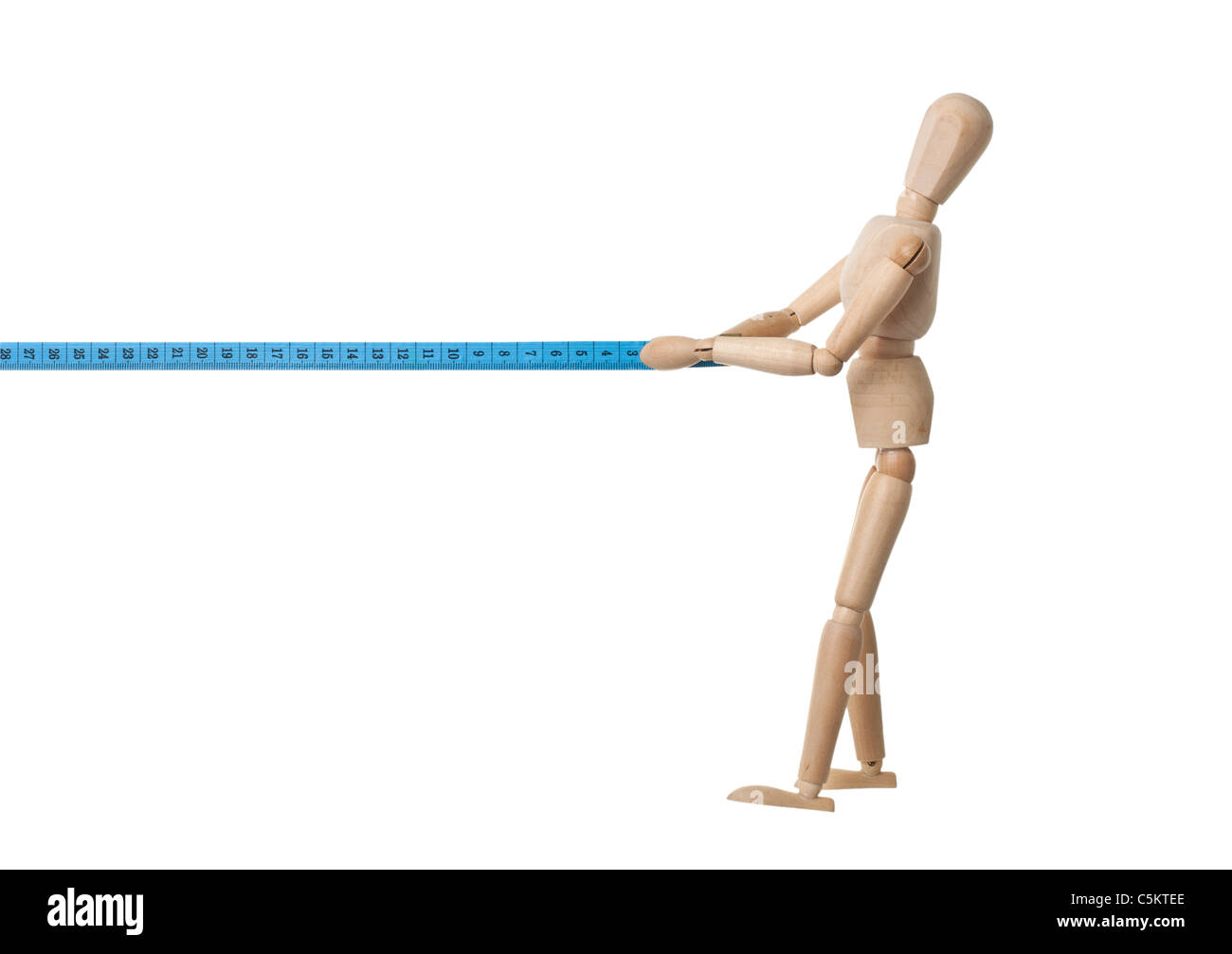 Mannequin pulling a measuring tape isolated on white background Stock Photo