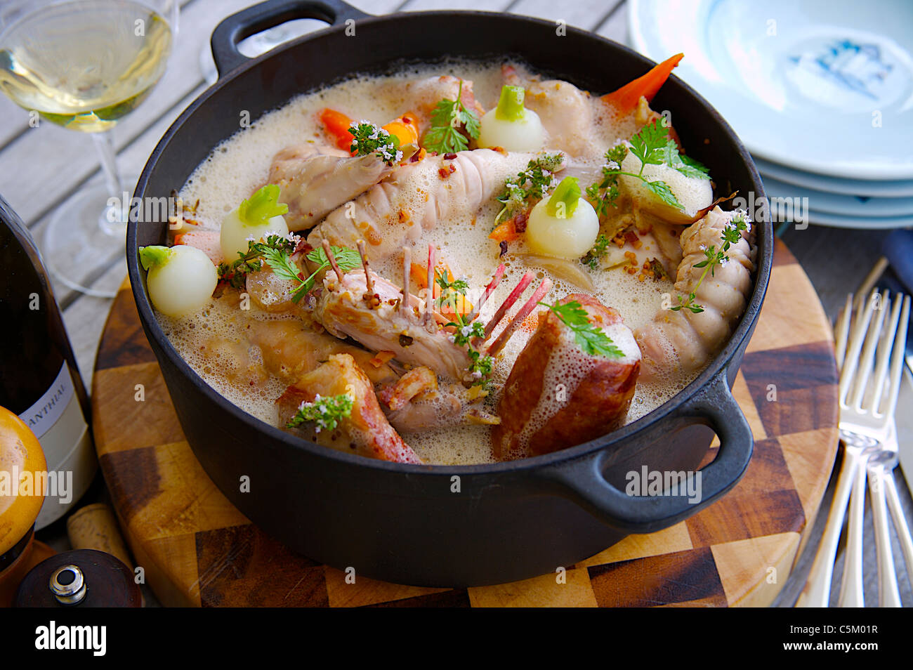 Rabbit Casserole served on a table outside in the garden Stock Photo