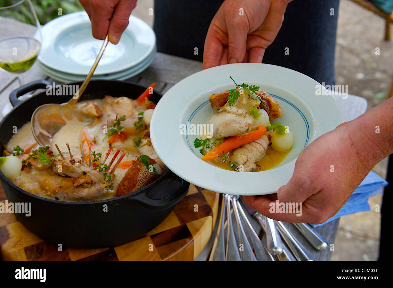 Rabbit Casserole served on a table outside in the garden Stock Photo
