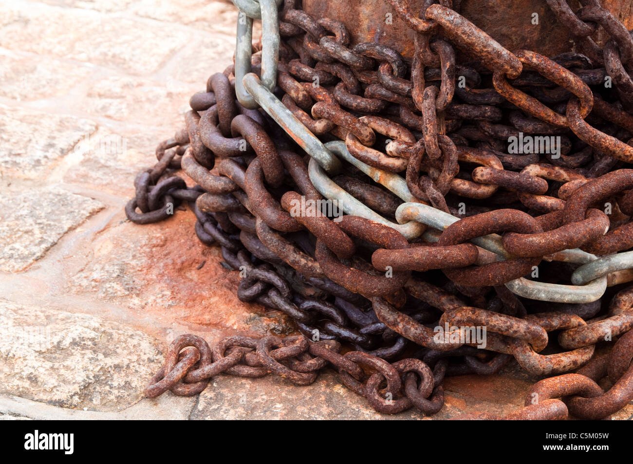 Large rusting chains around a capstan. UK Stock Photo