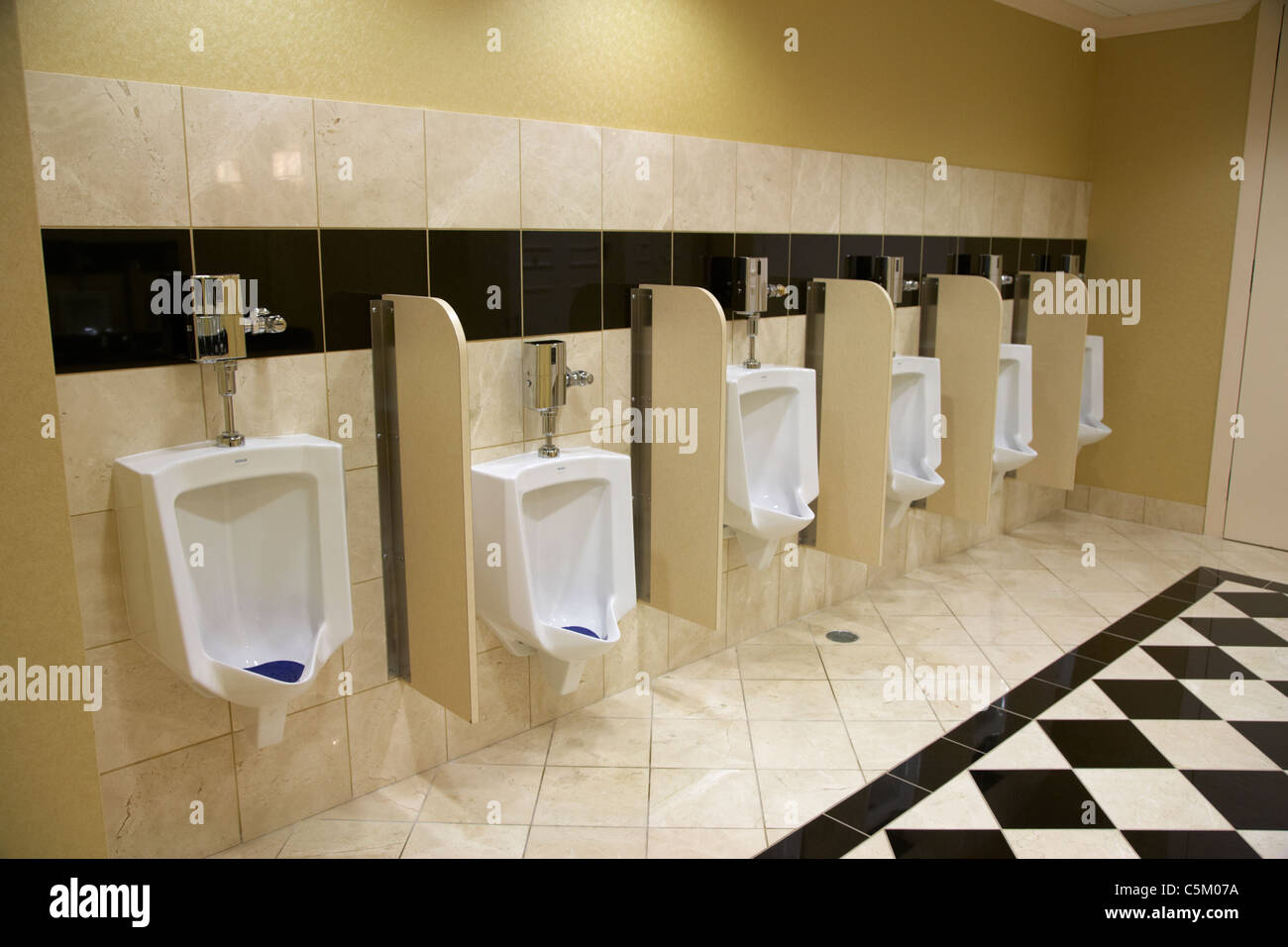 row of urinals in a hotel toilet in Nashville Tennessee USA Stock Photo