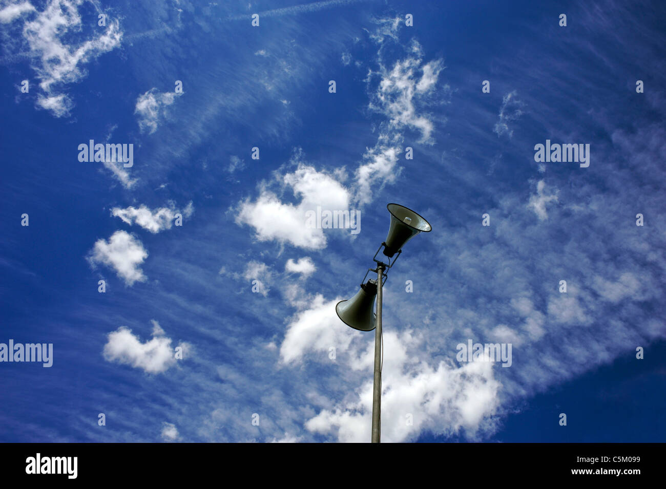 Public address speakers photographed against a summer sky. Stock Photo