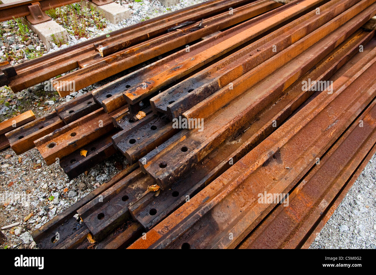 A pile of rusty metal tracks waiting to be used as part of a railway restoration project. UK. Stock Photo