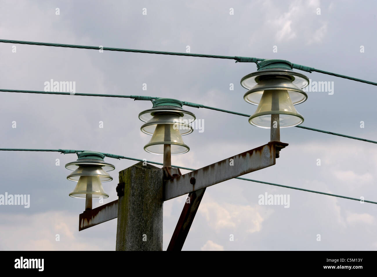 Overhead power lines with glass insulators, East Sussex, UK Stock Photo