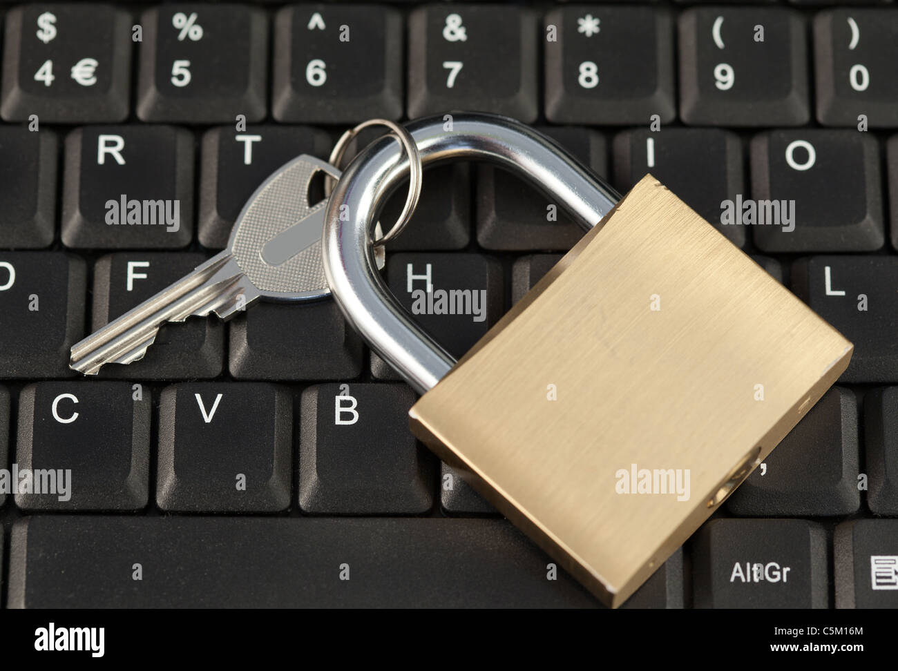 Padlock and key on a keyboard Stock Photo