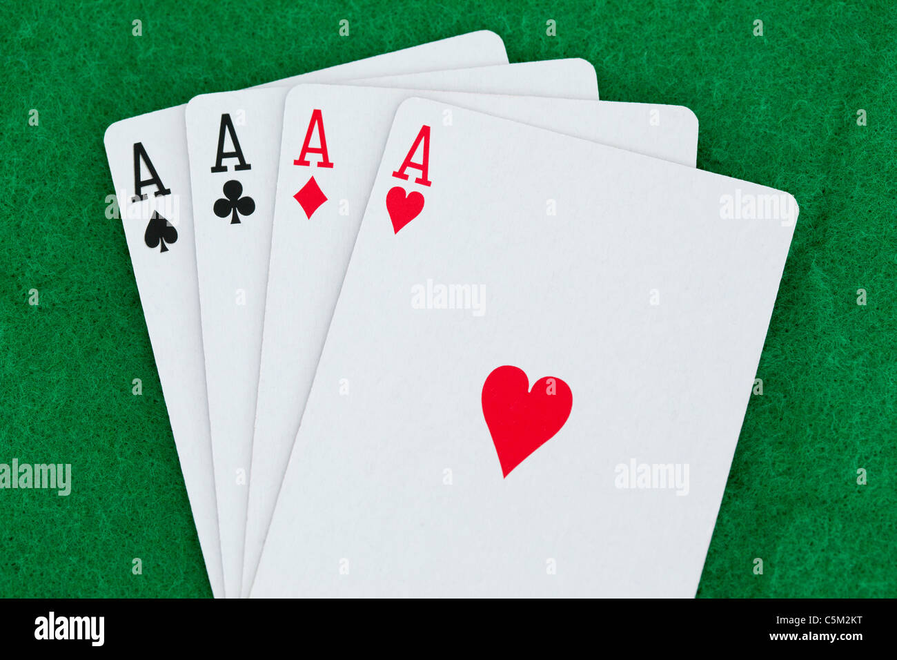 Playing cards on a green surface Stock Photo