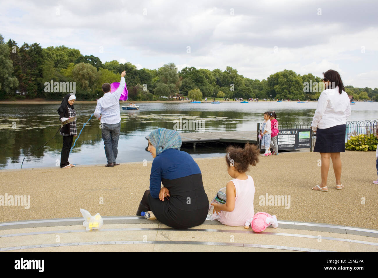 A Muslim family fly a kite in Hyde Park London. Stock Photo
