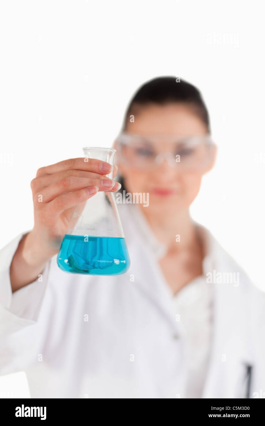 Female scientist with safety glasses holding a blue flask Stock Photo ...