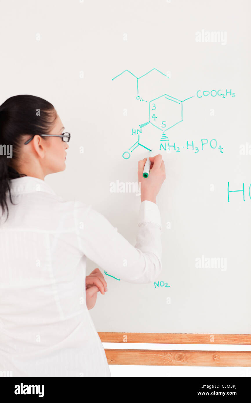 Scientist writing a formula on a whiteboard Stock Photo Alamy