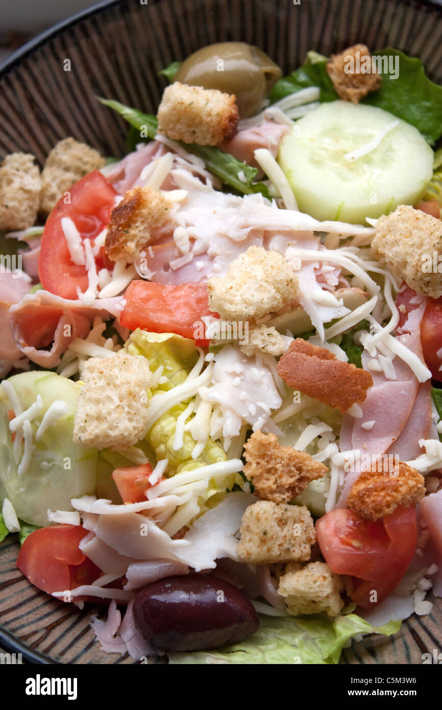 A delicious looking tossed chefs salad or antipasto with meat cheese and croutons. Stock Photo