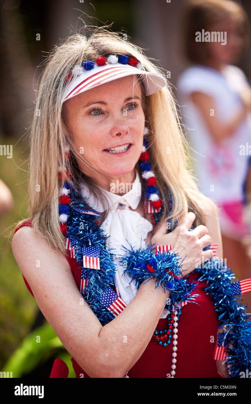 A woman dressed in patriotic costume stands for the pledge in the I'On