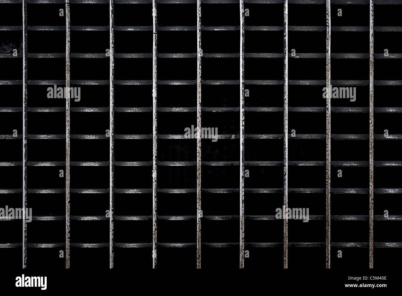 A metal subway grate texture that is worn and weathered. Stock Photo