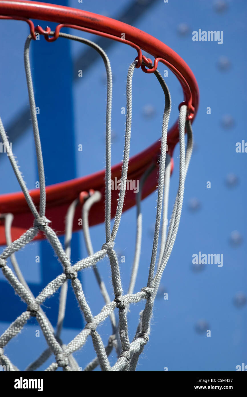 Closeup detail of a playground basketball goal and net. Shallow depth of field. Stock Photo