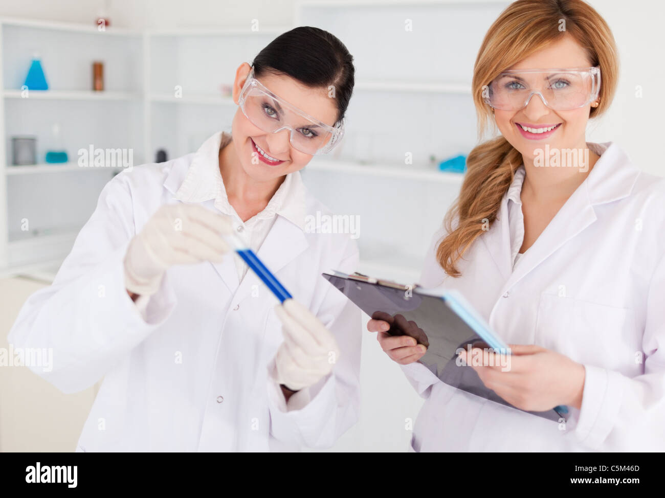 Two scientists looking at the camera while working in a lab Stock Photo