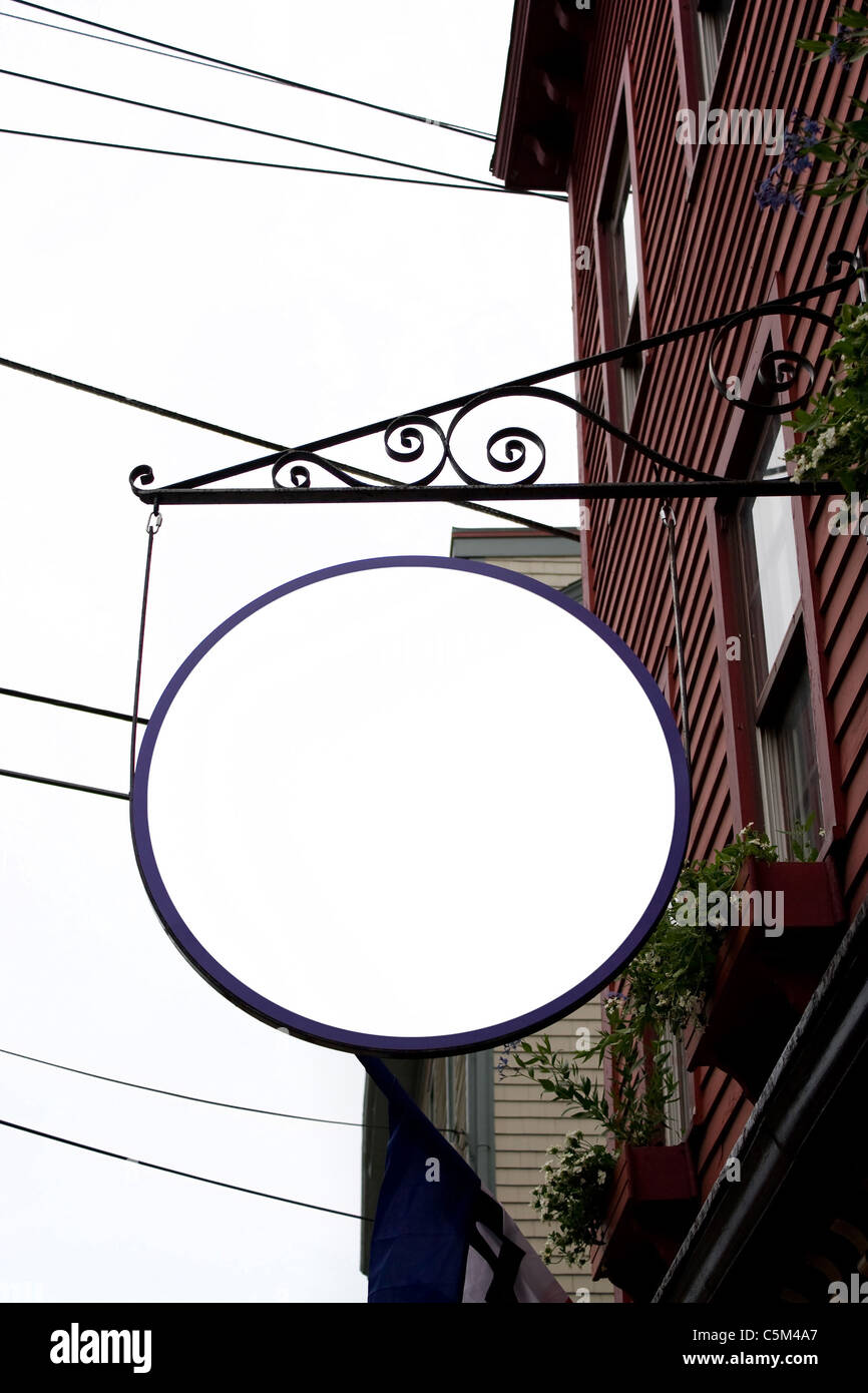 A blank hanging store sign in a circular shape with copy space for your text photo or message