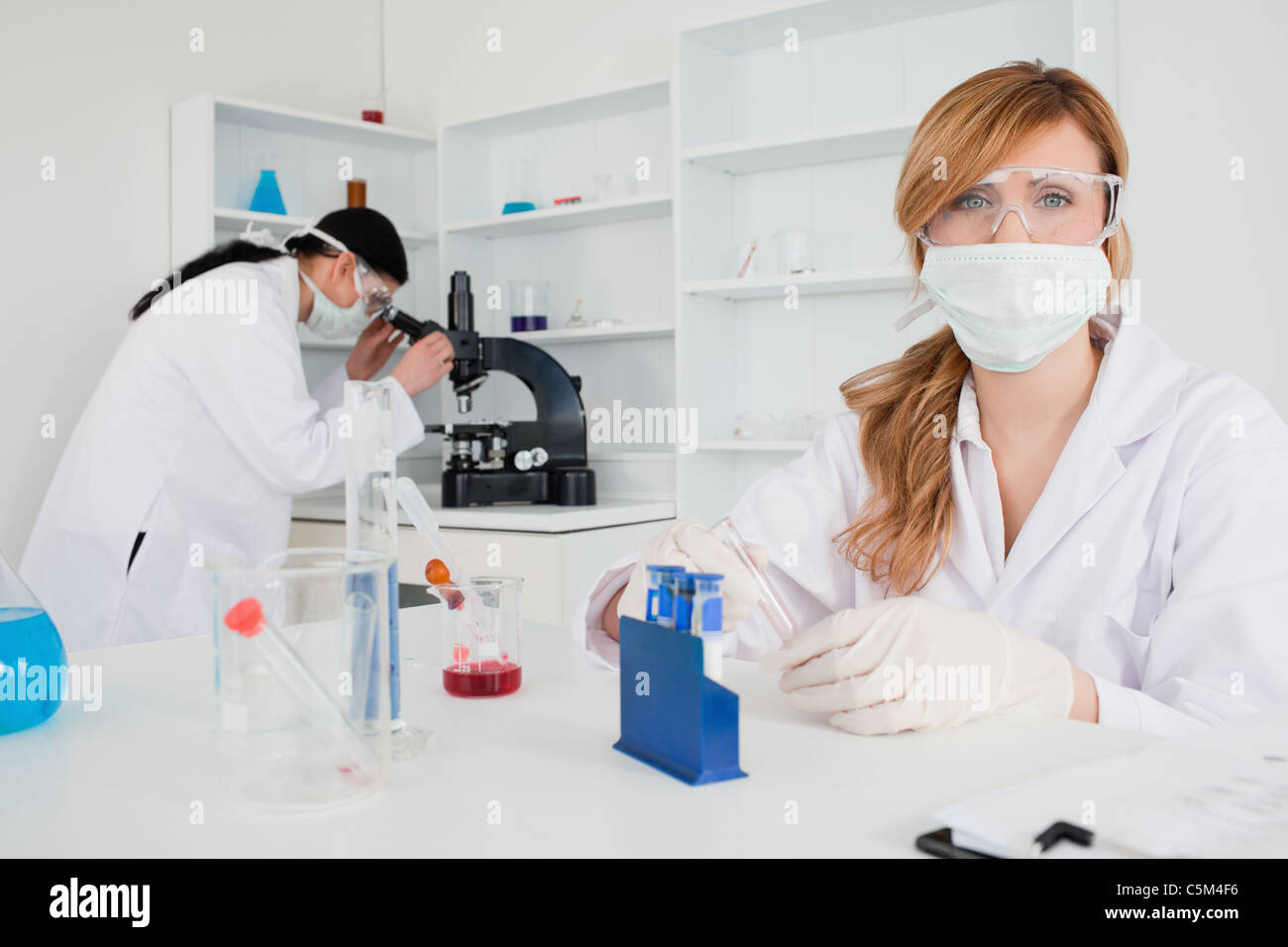 Two female scientists conducting an experiment Stock Photo