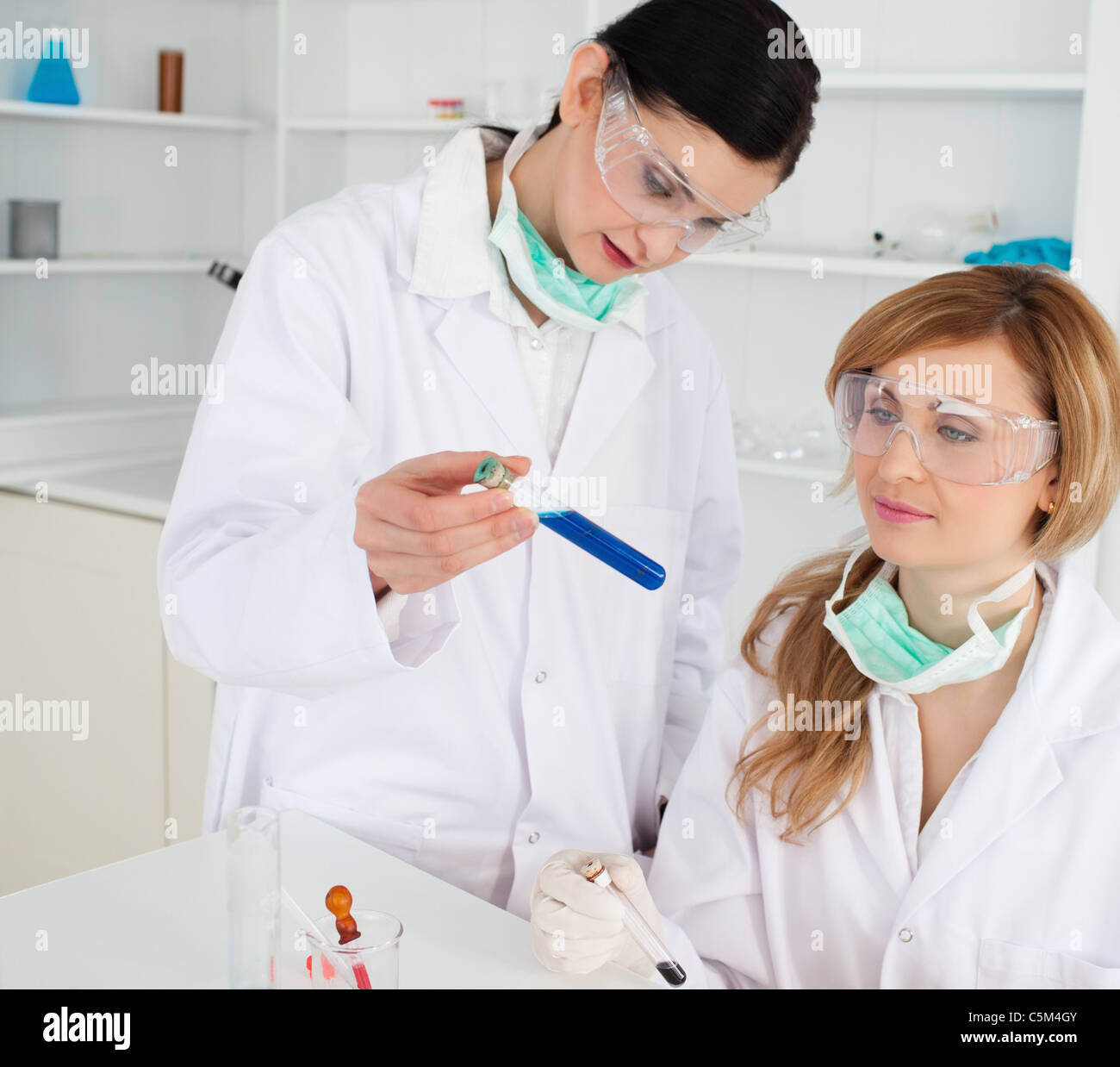 Female scientists looking at a test tube Stock Photo